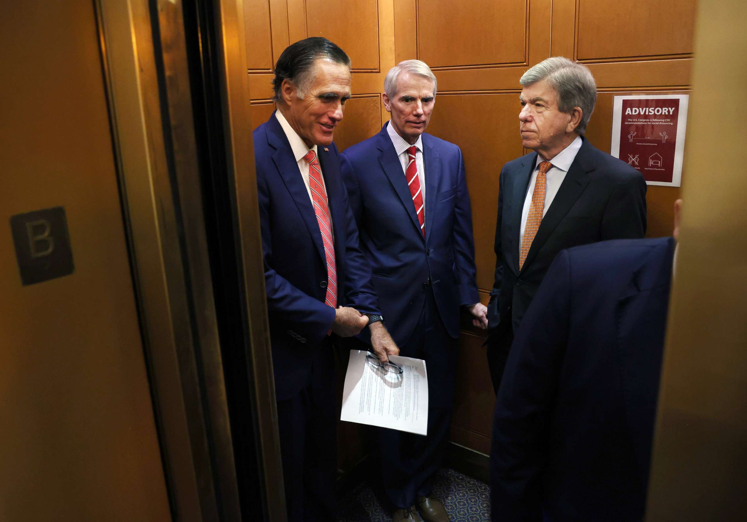 PHOTO: Sen. Mitt Romney, Sen. Rob Portman and Sen. Roy Blunt ride an elevator as they leave a bipartisan meeting on infrastructure at the U.S. Capitol on July 13, 2021, in Washington, D.C.