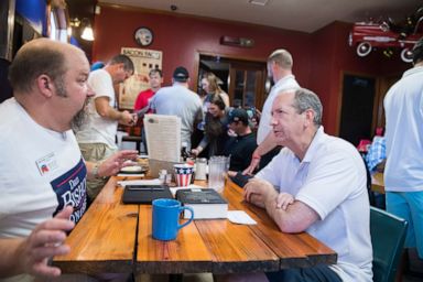 PHOTO: Dan Bishop, right, Republican candidate for North Carolinas 9th District, talks with supporters at Robins On Main diner in Hope Mills, N.C., on Saturday, August 10, 2019.