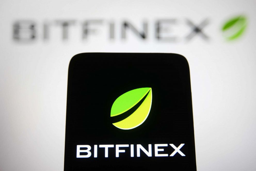 PHOTO: The Bitfinex logo, a cryptocurrency exchange company, is displayed on a smartphone and computer screen.