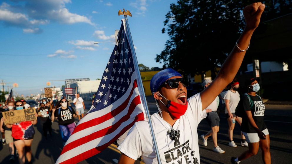 PHOTO: Protesters chant as they pass down a main thoroughfare during a Black Lives Matter march through a residential neighborhood calling for racial justice, July 13, 2020, in Valley Stream, N.Y.