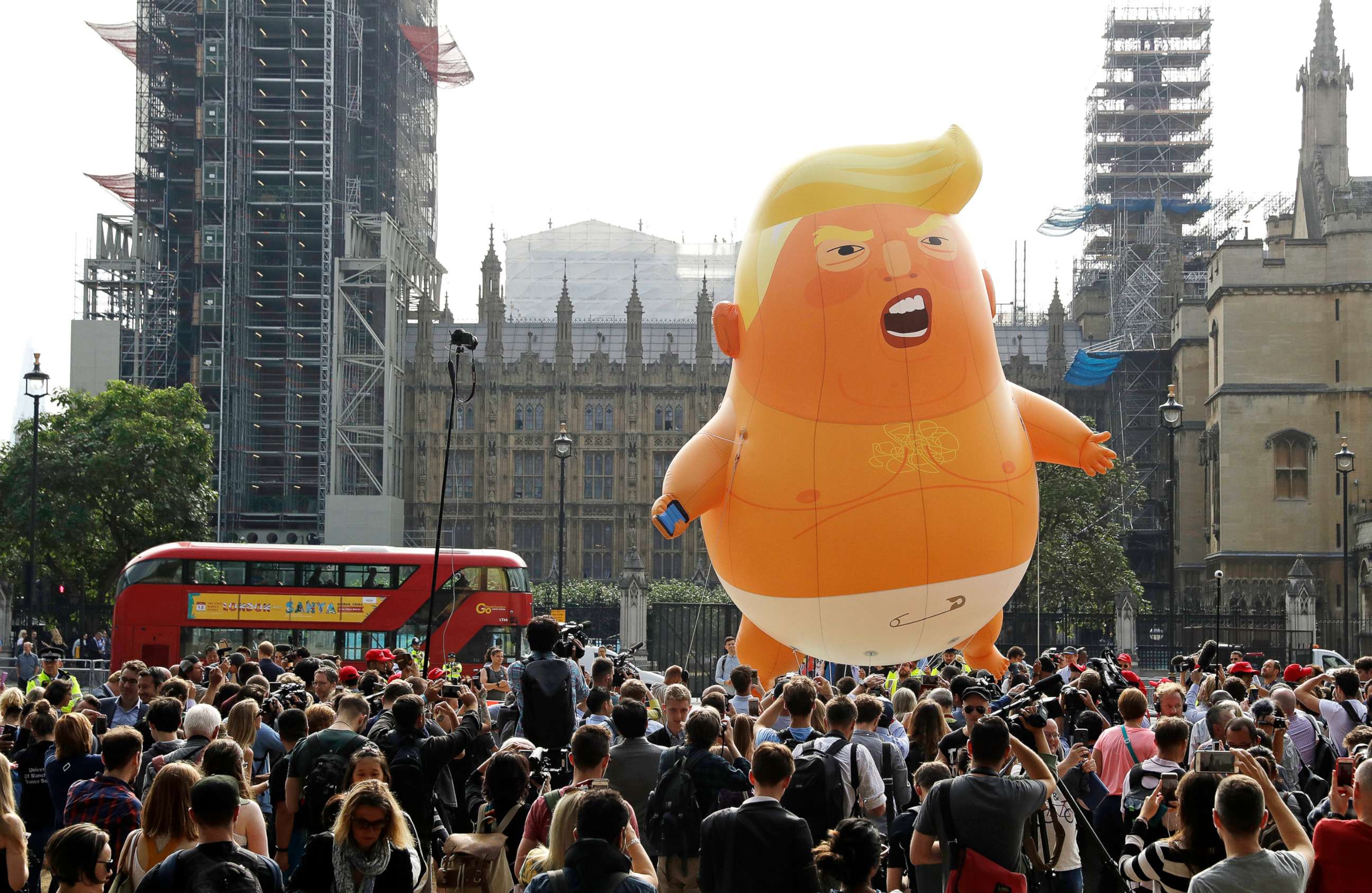 PHOTO: A six-meter high cartoon baby blimp of U.S. President Donald Trump is flown as a protest against his visit, in Parliament Square backdropped by the scaffolded Houses of Parliament and Big Ben in London, July 13, 2018.