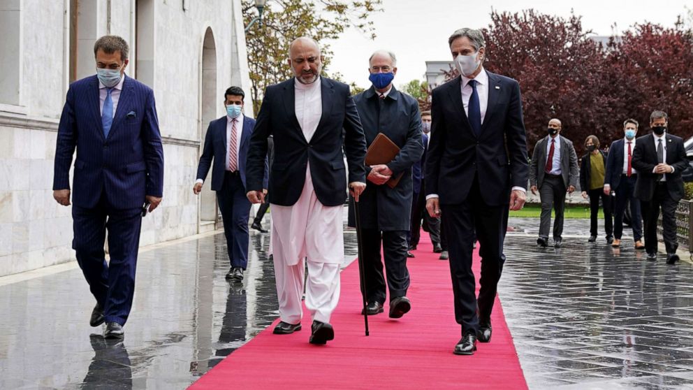 PHOTO: U.S. Secretary of State Antony Blinken, center right, walks with Afghanistan's Foreign Minister Mohammad Haneef Atmar, center left, at the presidential palace in Kabul, Afghanistan, April 51, 2021.