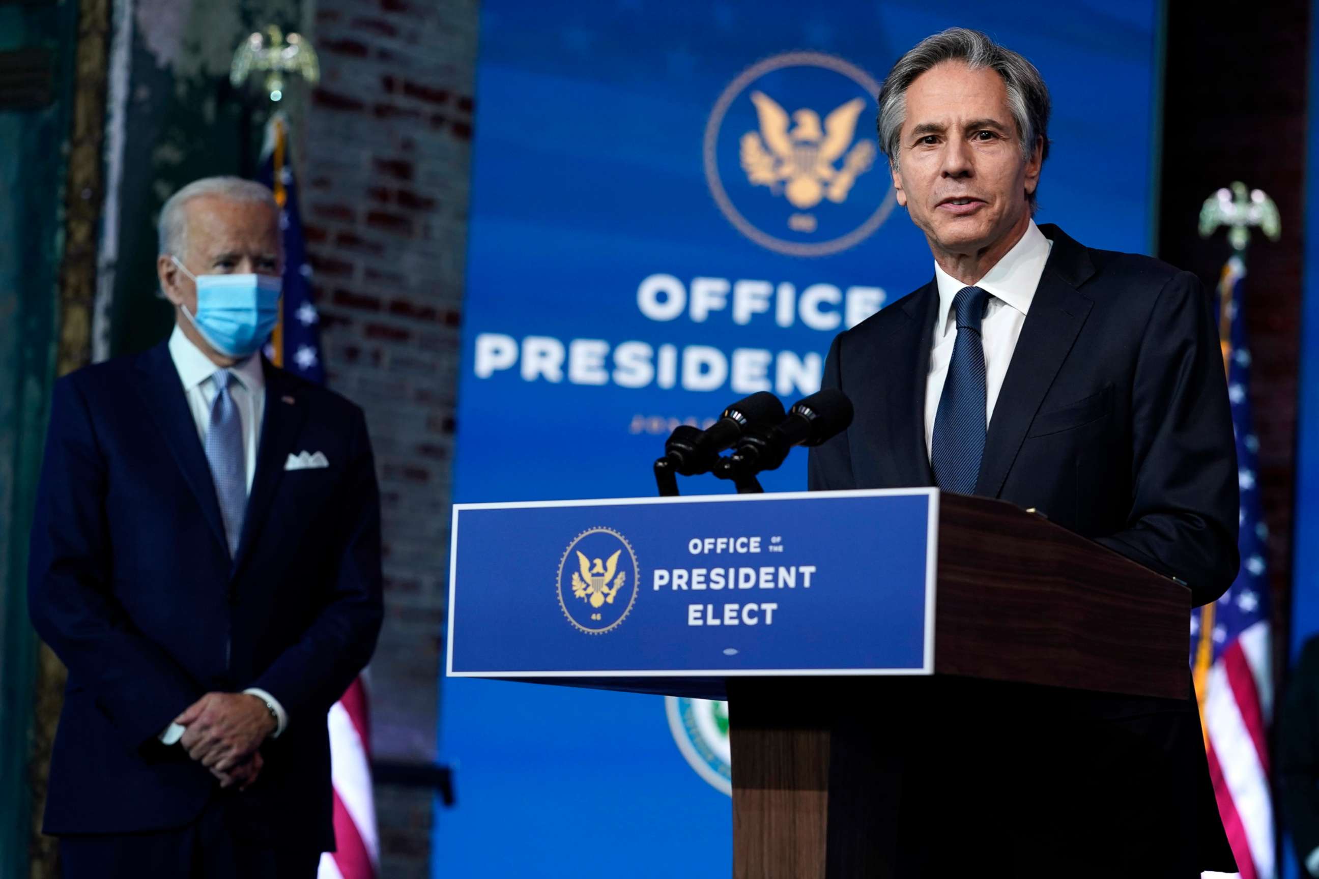 PHOTO: President-elect Joe Biden listens as his Secretary of State nominee Tony Blinken speaks at The Queen theater, Nov. 24, 2020, in Wilmington, Del.