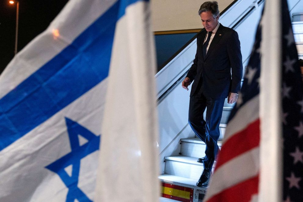 PHOTO: U.S. Secretary of State Antony Blinken, walks by U.S. and Israeli flags, at Ben Gurion Airport, near Tel Aviv, Israel, March 26, 2022.
