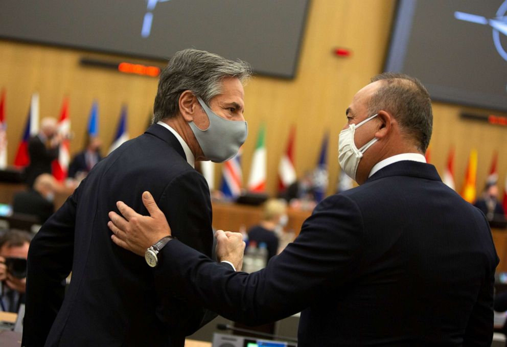 PHOTO: Secretary of State Antony Blinken, left, speaks with Turkish Foreign Minister Mevlut Cavusoglu during a meeting of NATO foreign ministers at NATO headquarters in Brussels on March 23, 2021.