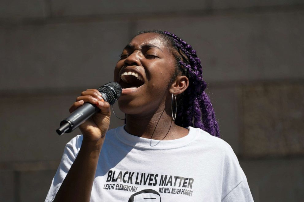 PHOTO: Savannah Blackwell sings "Lift Every Voice and Sing," also known as the Black national anthem, during a rally at City Hall as part of the nationwide Strike For Black Lives, July 20, 2020, in Seattle.