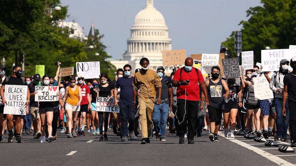 PHOTO: Demonstrators march down Pennsylvania Avenue during a protest against police brutality and the death of George Floyd, on June 3, 2020, in Washington, D.C.