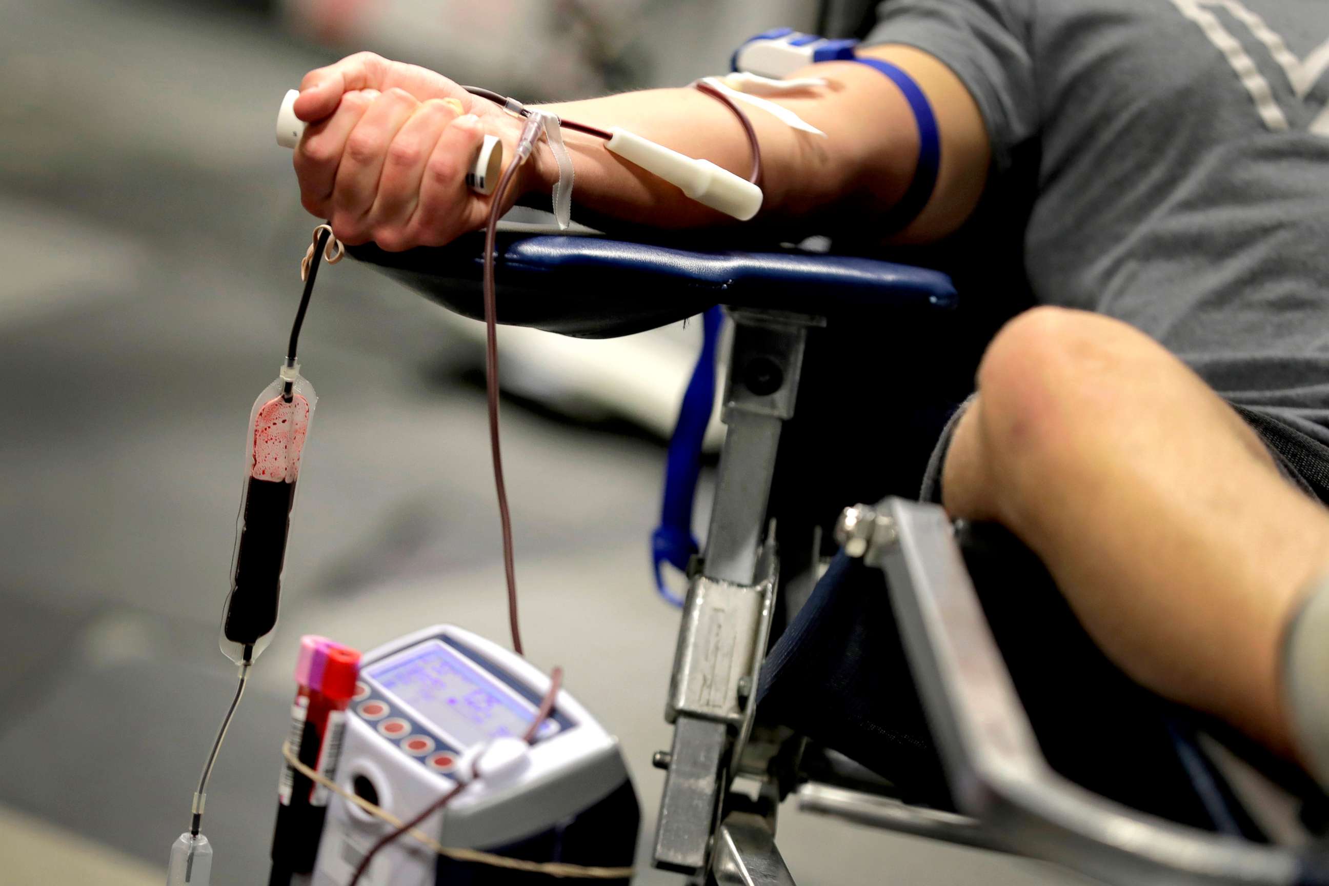PHOTO: A man donates blood at a temporary blood bank set up in a church's fellowship hall, March 24, 2020, in Tempe, Ariz.