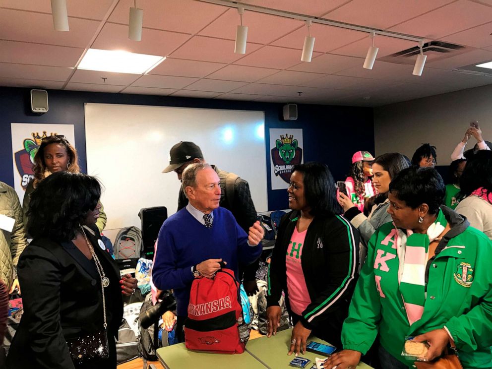 PHOTO: Former New York City Mayor and presidential hopeful Michael Bloomberg talks to volunteers assembling backpacks at Scholarmade Achievement Place in Little Rock, Ark., Jan. 20, 2020. 