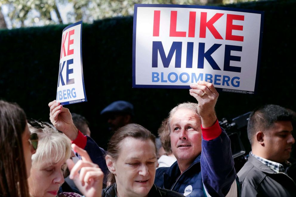 PHOTO: A supporter holds up signs as Democratic presidential candidate former New York City Mayor Mike Bloomberg speaks during a campaign event held at The Rustic Restaurant, Feb. 27, 2020, in Houston.
