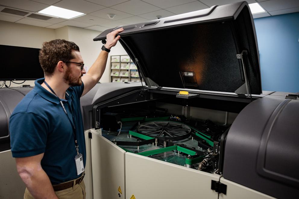 PHOTO: Director of the Board of Elections Tyler Burns holds open the mail sorter during a mail-in ballot processing demonstration at the Board of Elections office on Sept. 30, 2024, in Doylestown, Pa.