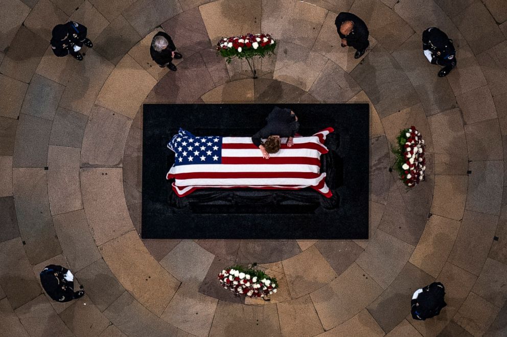 PHOTO: Former Sen. Elizabeth Dole, the wife of former Senate Majority Leader Bob Dole, lays across the casket of her husband as he lies in state in the Rotunda of the U.S. Capitol on Dec. 9, 2021 in Washington, D.C. 