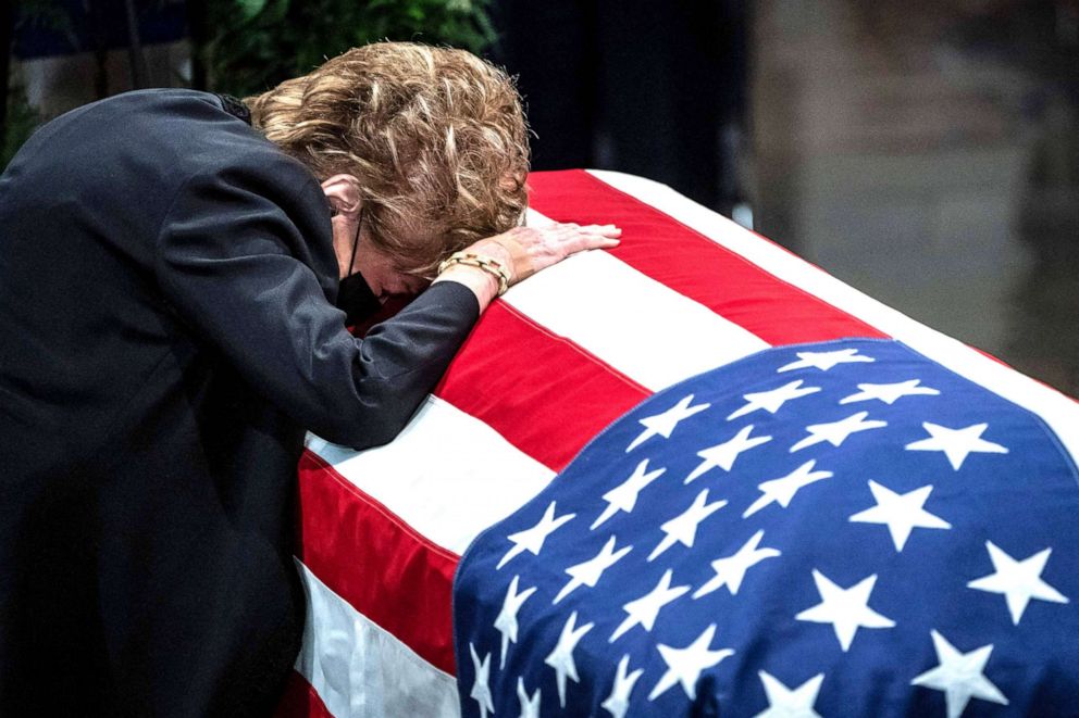 PHOTO: Former US Senator Elizabeth Dole rests her head on her husband's casket as  former Senator Bob Dole lies in state at the US Capitol in Washington, D.C., Dec. 9, 2021.  