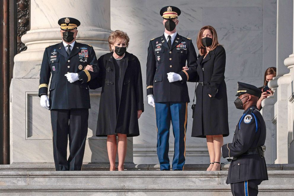 PHOTO: Elizabeth Dole and her daughter Robin watch as a joint services military bearer team moves the casket of former Sen. Bob Dole, during arrival at the U.S. Capitol, where he will lie in state in the Rotunda, Dec. 9, 2021, in Washington, D.C.