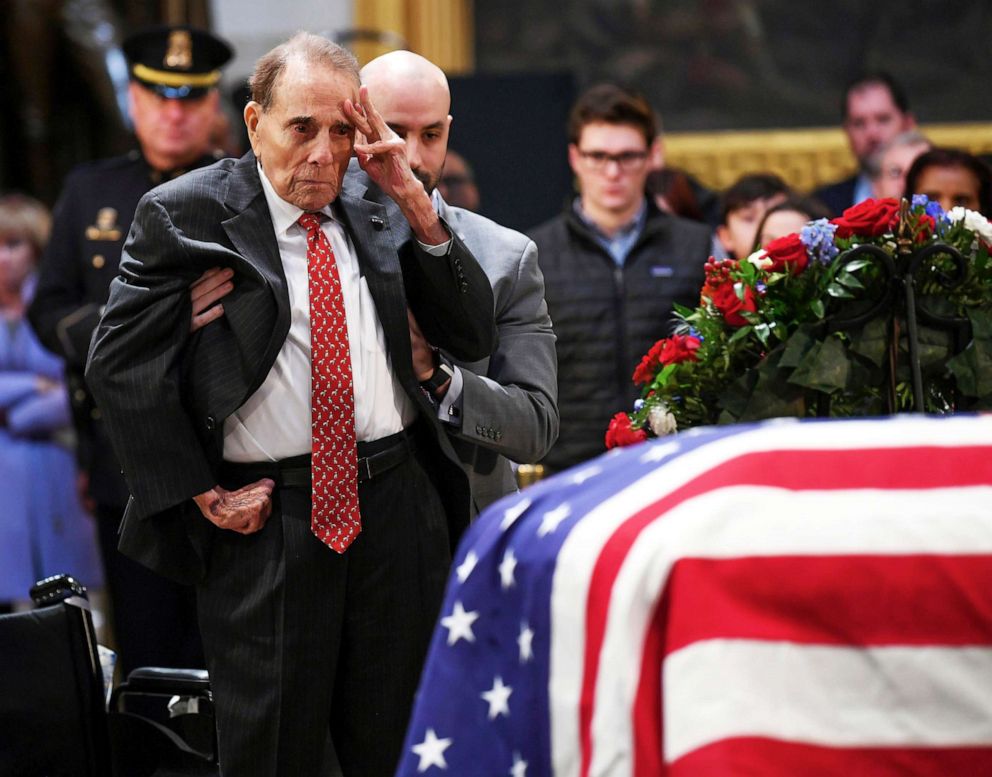 Former Sen. Bob Dole salutes the casket of President George H.W. Bush who lies in state at the U.S. Capitol Rotunda in Washington D.C., Dec. 4, 2018.