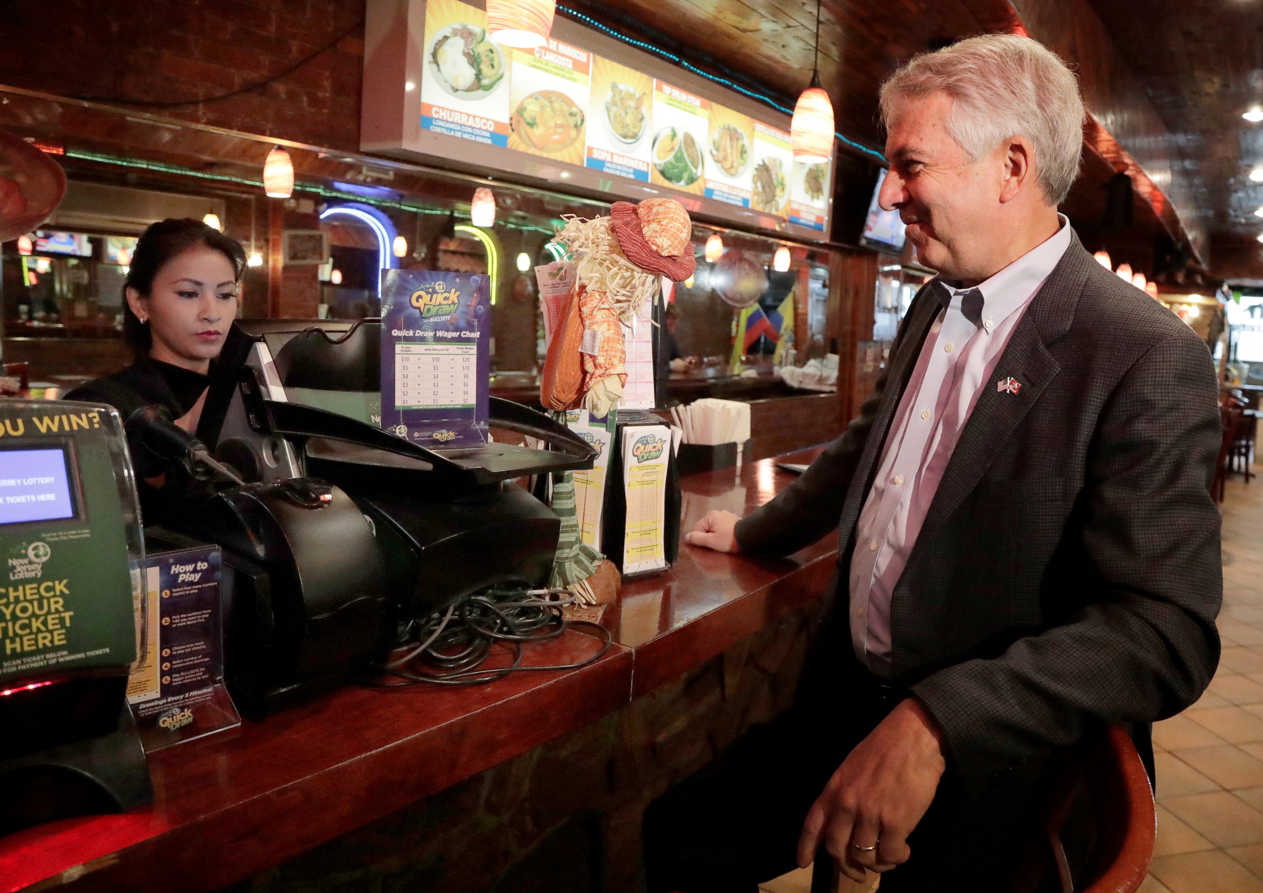 PHOTO: Bob Hugin, right, the Republican candidate in the U.S. Senate race in New Jersey, purchases a Mega Millions lottery ticket at Sabor Latino, a restaurant where he held a news conference Tuesday, Oct. 23, 2018, in Newark, N.J.