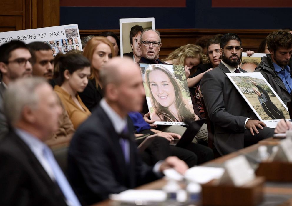 PHOTO: Family members of those who died aboard Ethiopian Airlines Flight 302 hold photos of their loved ones as Dennis Muilenburg, President and CEO of the Boeing Company, testifies before congressional lawmakers Washington, Oct. 30, 2019.