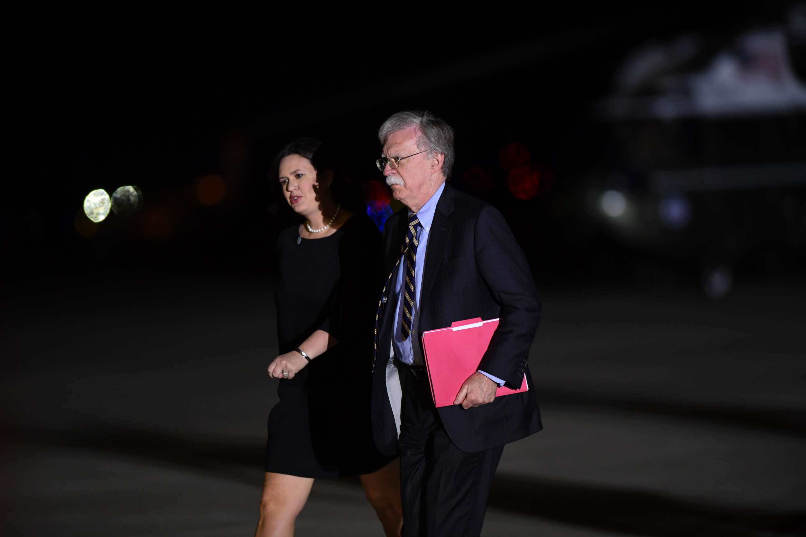 PHOTO: White House press secretary Sarah Huckabee Sanders and national security adviser John Bolton arrive at Andrews Air Force Base in Md., to greet three Americans detained in North Korea for more than a year, May 10, 2018. 