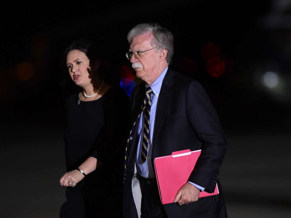 PHOTO: White House press secretary Sarah Huckabee Sanders and national security adviser John Bolton arrive at Andrews Air Force Base in Md., to greet three Americans detained in North Korea for more than a year, May 10, 2018.