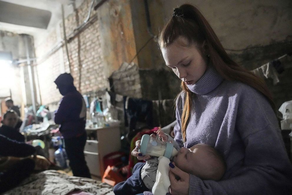 PHOTO: A young woman feeds a baby in a bomb shelter in Mariupol, Ukraine, March 7, 2022.