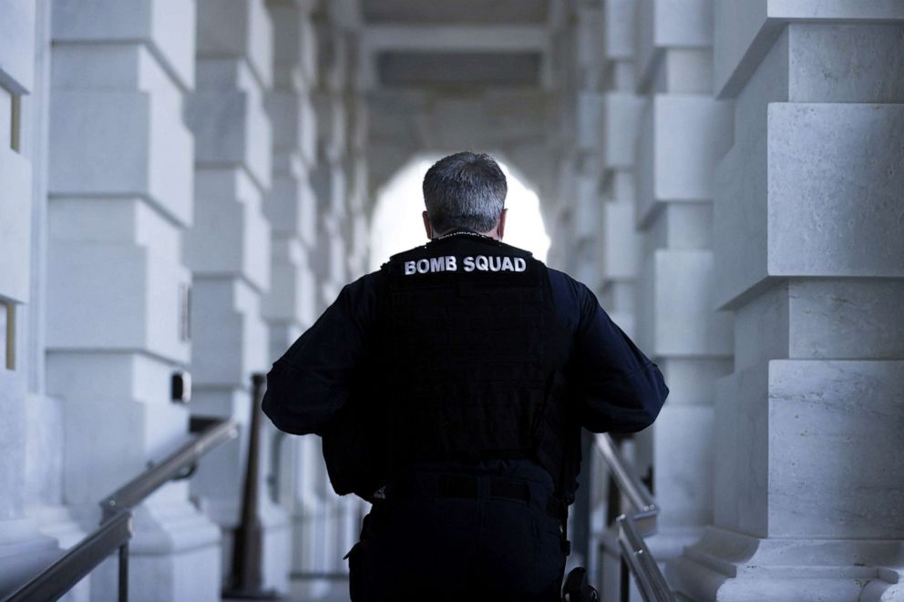 PHOTO: A member of the U.S. Capitol Police bomb squad walks to a Capitol entrance as police and National Guard secure the Capitol grounds after they warned that a militia group might try to attack the Capitol complex in Washington, D.C., March 4, 2021.