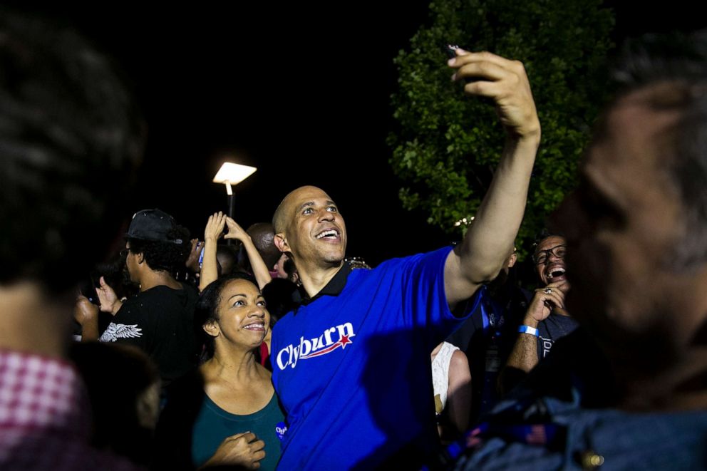PHOTO: Senator Cory Booker, a Democrat from New Jersey and 2020 presidential candidate, center right, takes a selfie photograph with an attendee during Jim Clyburn's World Famous Fish Fry event in Columbia, South Carolina, U.S., on Friday, June 21, 2019.