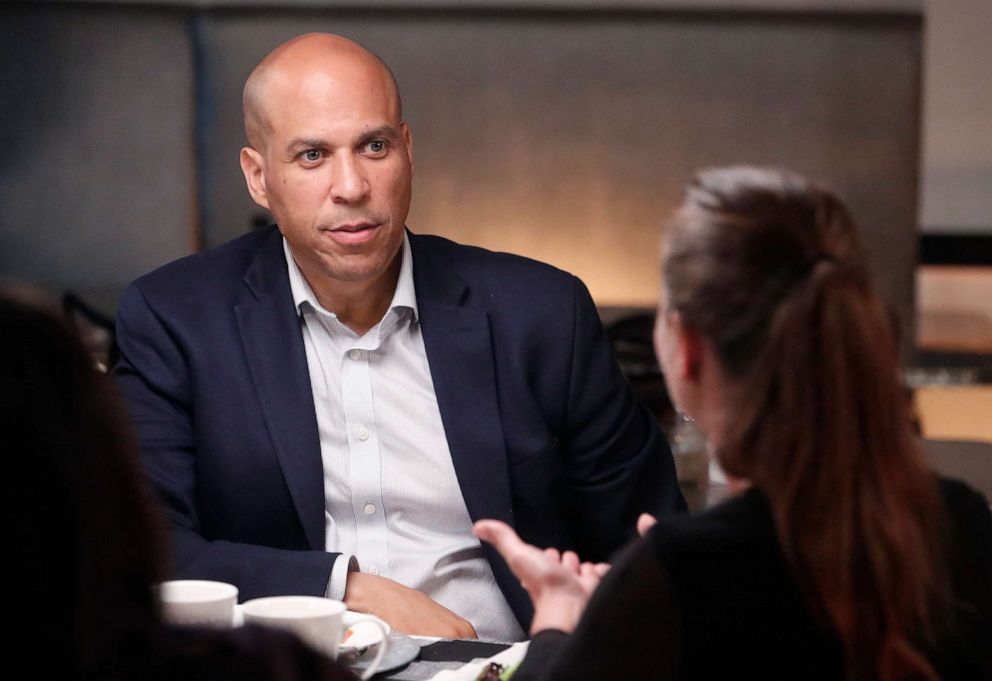 PHOTO: Democratic presidential candidate Cory Booker listens to Phyllis Van Amburgh during a dinner with undecided voters at a restaurant in Newark, N.J.