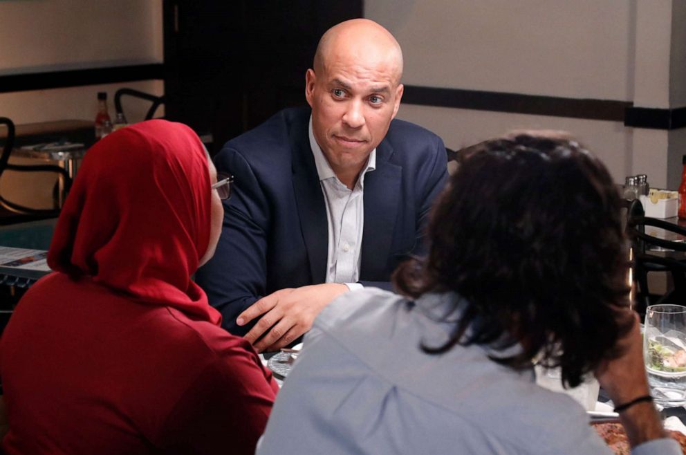 PHOTO: 2020 Democratic presidential candidate Cory Booker has dinner with three undecided voters at a restaurant in Newark, N.J., including Tria Jones, left and Bijan Roghanchi, right.