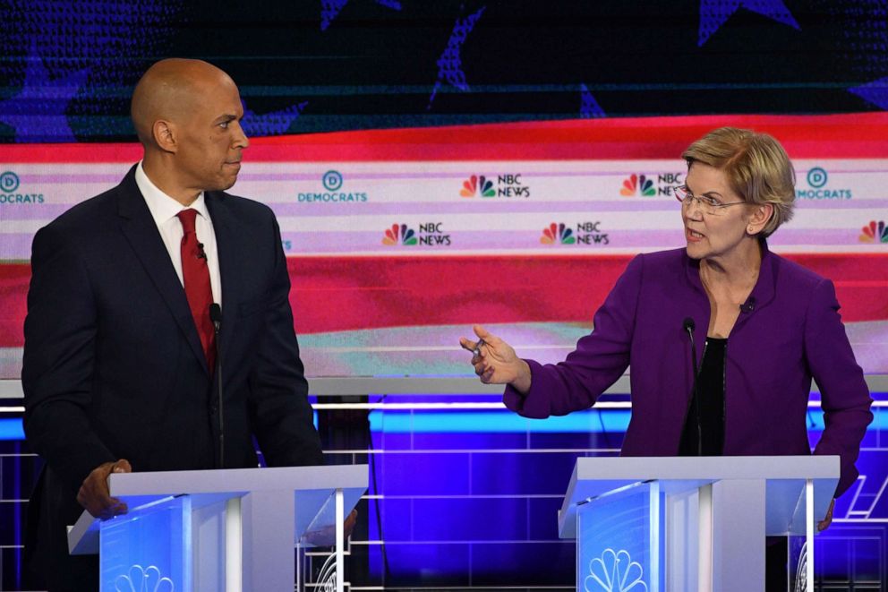 PHOTO: Cory Booker and Elizabeth Warren participate in the first Democratic primary debate hosted by NBC News at the Adrienne Arsht Center for the Performing Arts in Miami, Florida, June 26, 2019.