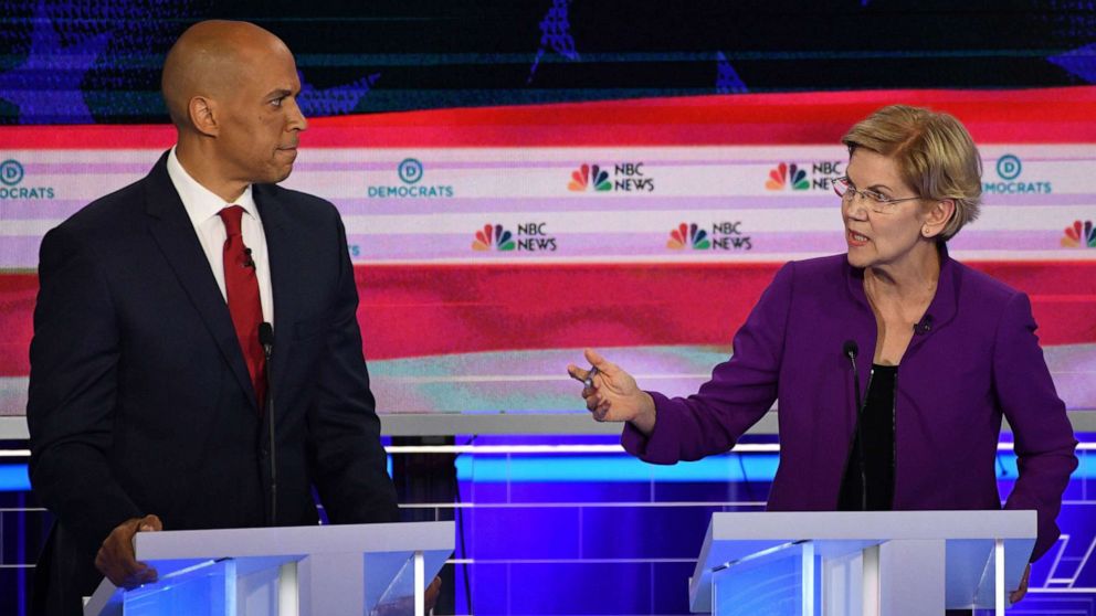 PHOTO: Cory Booker and Elizabeth Warren participate in the first Democratic primary debate hosted by NBC News at the Adrienne Arsht Center for the Performing Arts in Miami, Florida, June 26, 2019.