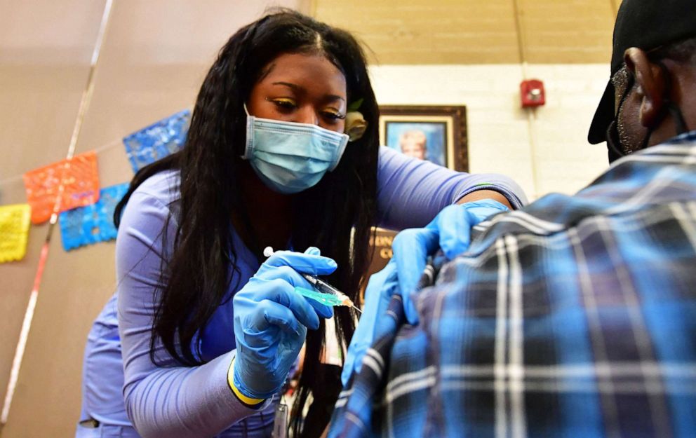 PHOTO: Vocational Nurse Cleopatra Oniya administers the Pfizer booster shot at a Covid vaccination and testing site in Los Angeles, May 5, 2022.