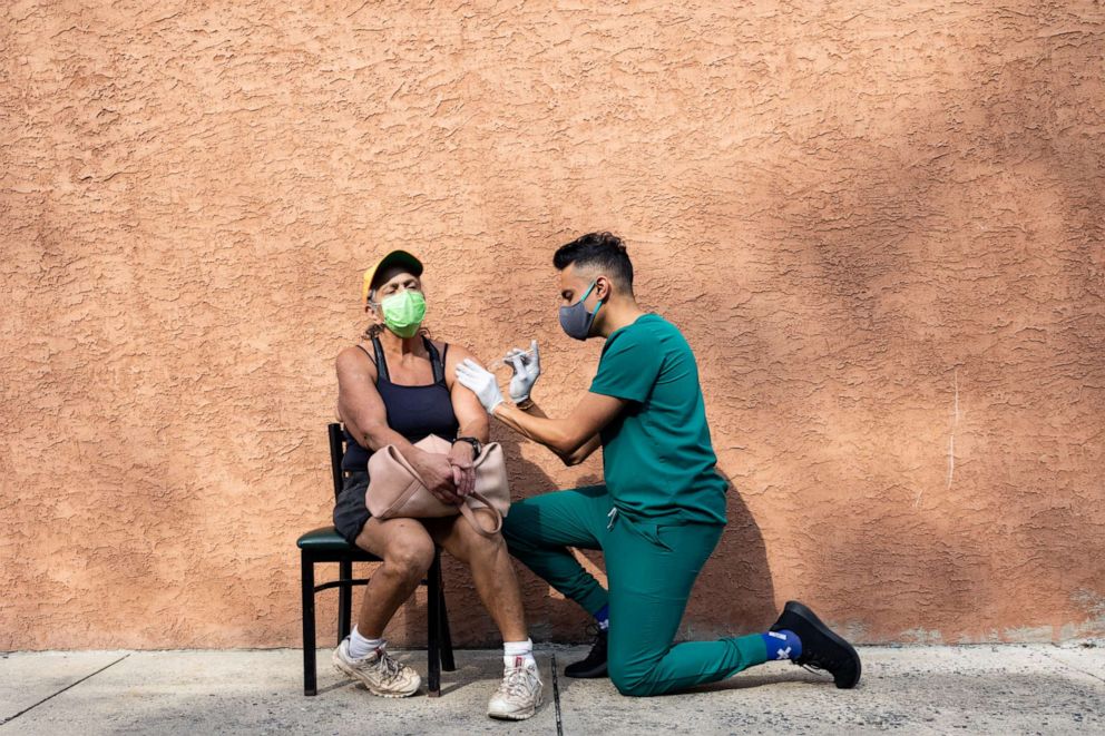 A woman receives the Pfizer-BioNTech COVID-19 vaccine as a booster dose at Skippack Pharmacy in Schwenksville, Pennsylvania on Aug. 14, 2021.