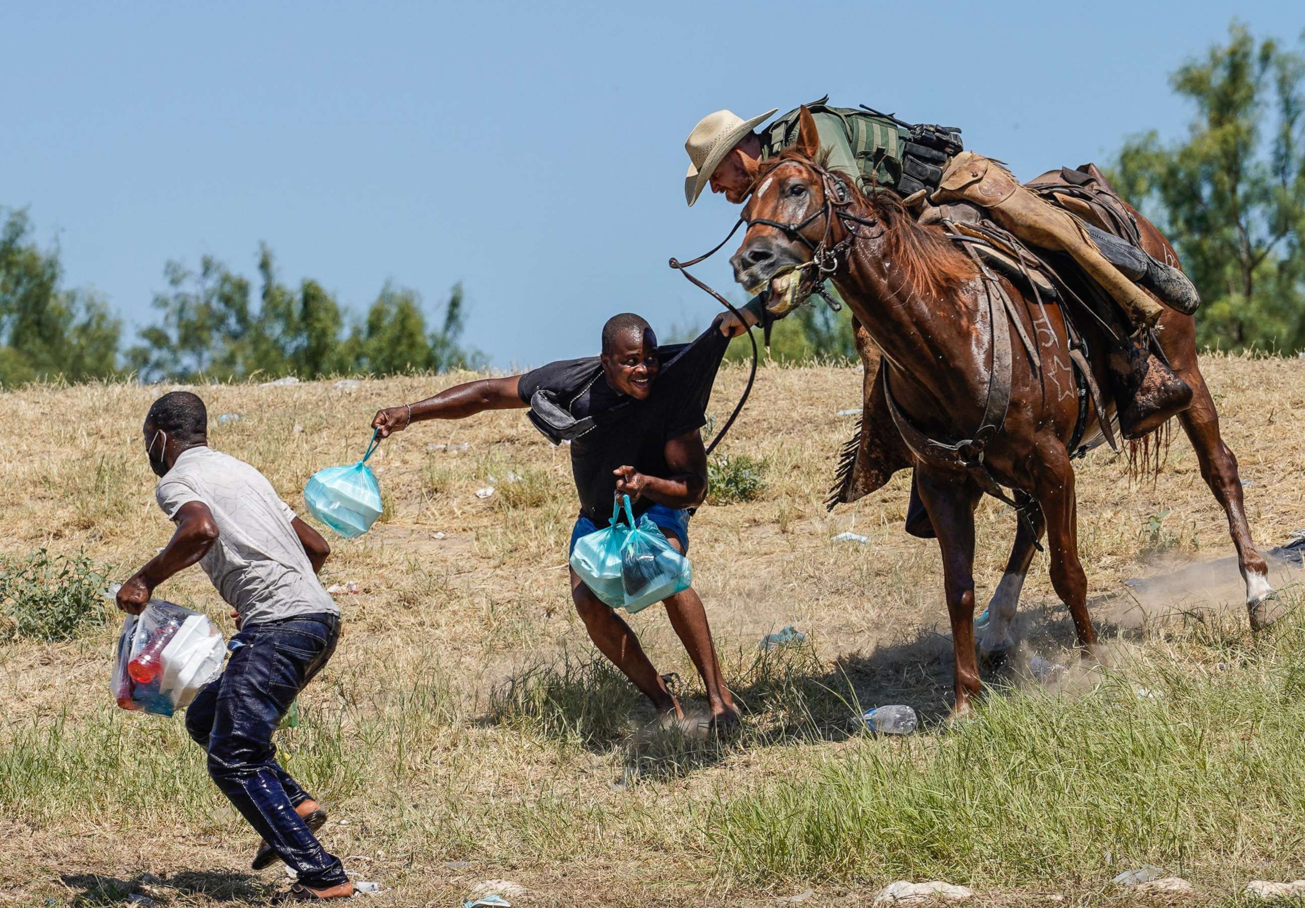 PHOTO: A United States Border Patrol agent on horseback tries to stop a Haitian migrant from entering an encampment on the banks of the Rio Grande near the Acuna Del Rio International Bridge in Del Rio, Texas, Sept. 19, 2021.