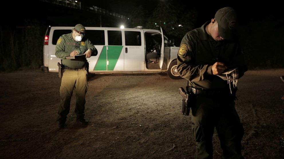 PHOTO: Border Patrol agents process migrants under the Roma Ciudad Miguel Aleman International Bridge, which spans the Rio Grande border with Mexico, in Roma, Texas, Oct. 1, 2021.