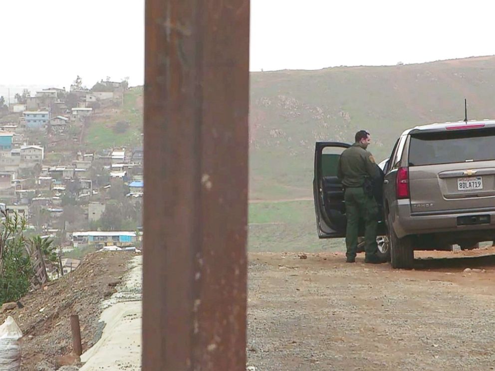 PHOTO: On the left, the Tijuana, Mexico side of the U.S. southern border. On the right, a Customs and Border Protection agent on the U.S. side in San Diego.