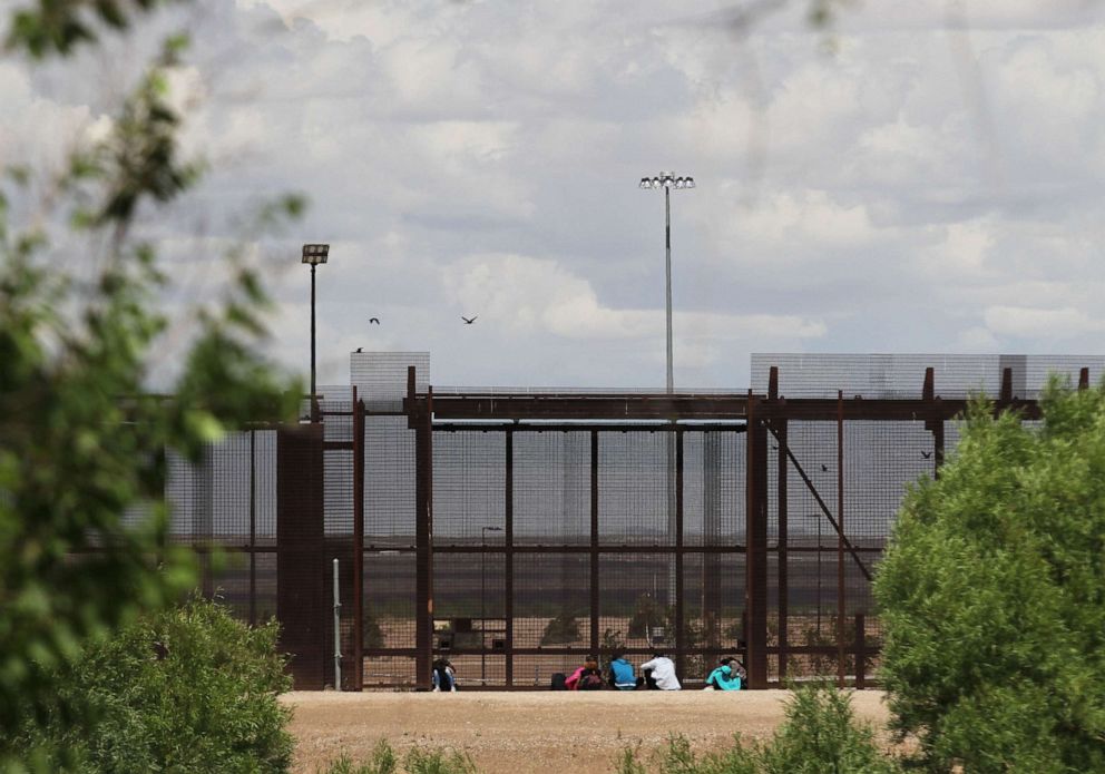 PHOTO: A group of migrants wait to be stopped by the Border Patrol at the border wall in El Paso, Texas as seen from Ciudad Juarez, Mexico, April 24, 2019.