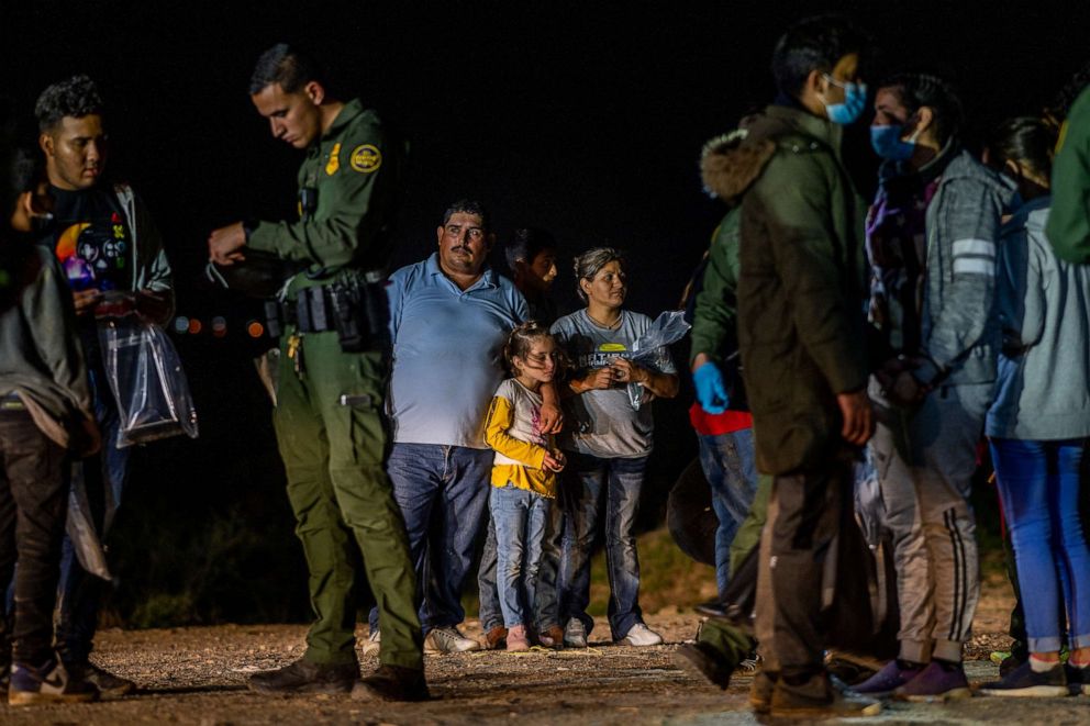 PHOTO: A migrant family stands waiting to be processed at the border, May 5, 2022, in Roma, Texas. 