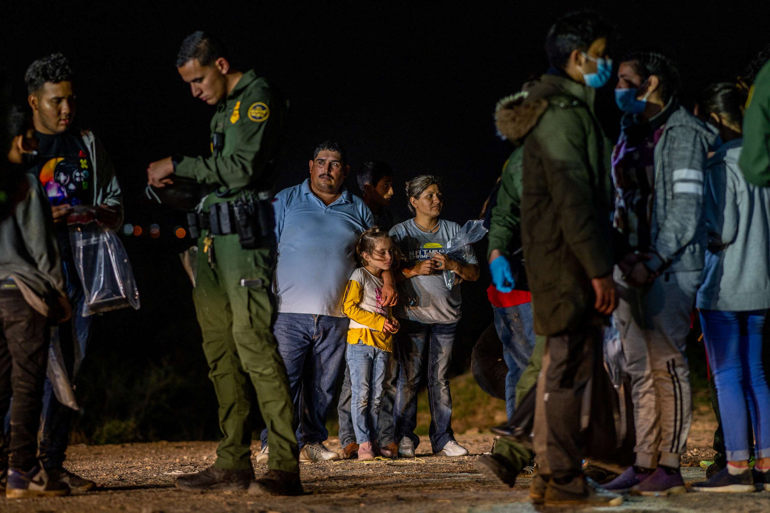 PHOTO: A migrant family stands waiting to be processed at the border, May 5, 2022, in Roma, Texas. 