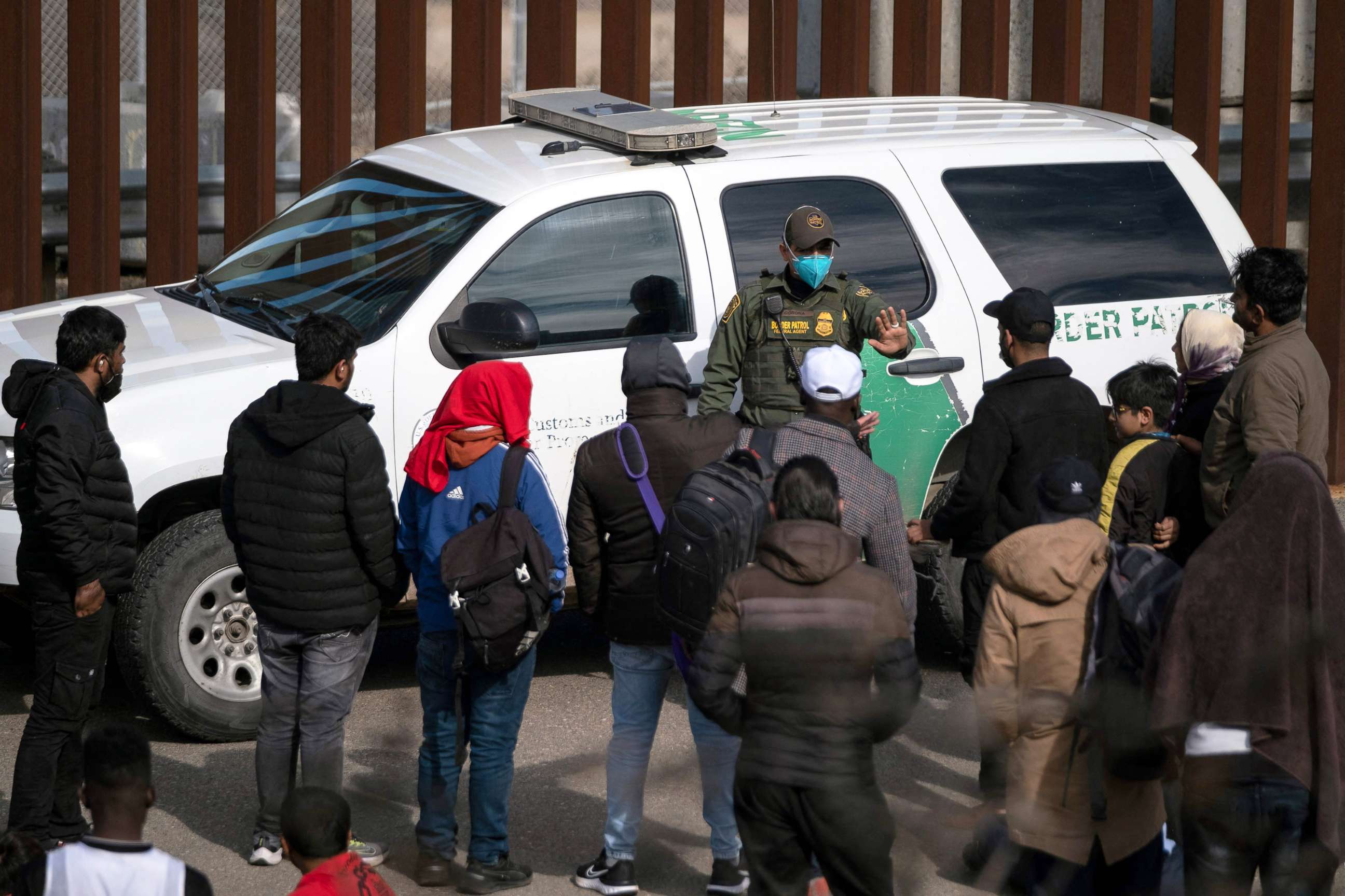 PHOTO: A border patrol agent talks to a group of migrants, mostly from African countries, before processing them after they crossed the US-Mexico border, taken from Tijuana, Baja California state, Mexico, on Nov. 11, 2022.