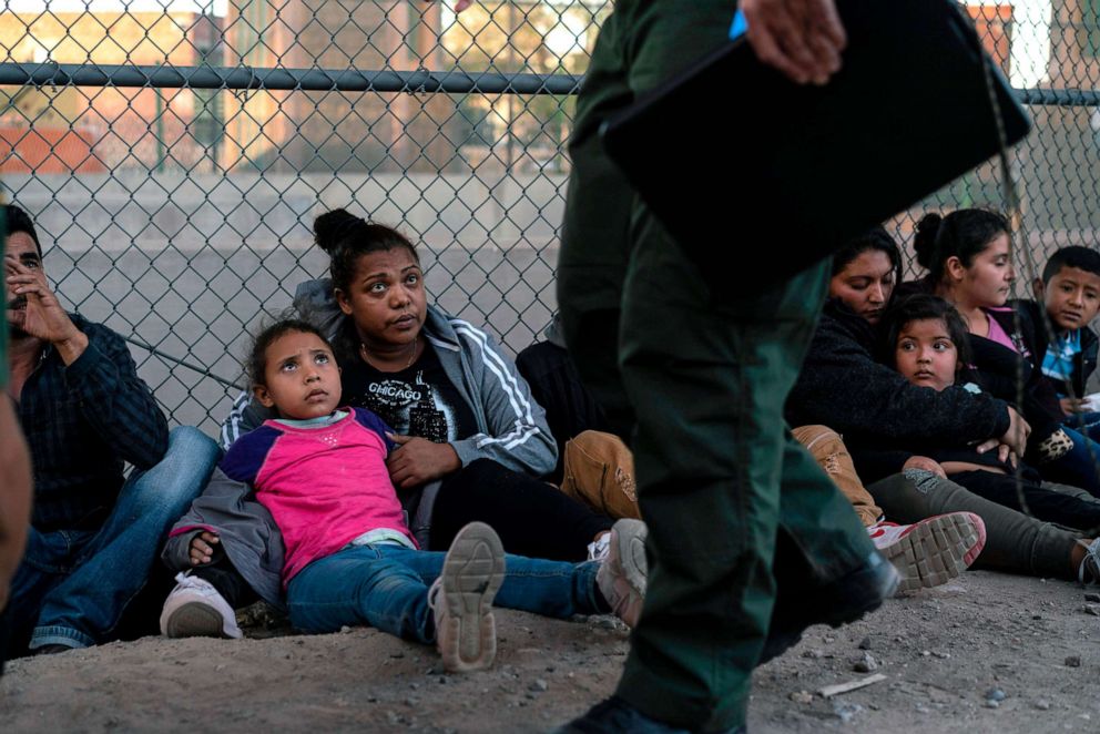 PHOTO: Migrants, mostly from Central America, wait to board a van which will take them to a processing center, May 16, 2019, in El Paso, Texas.