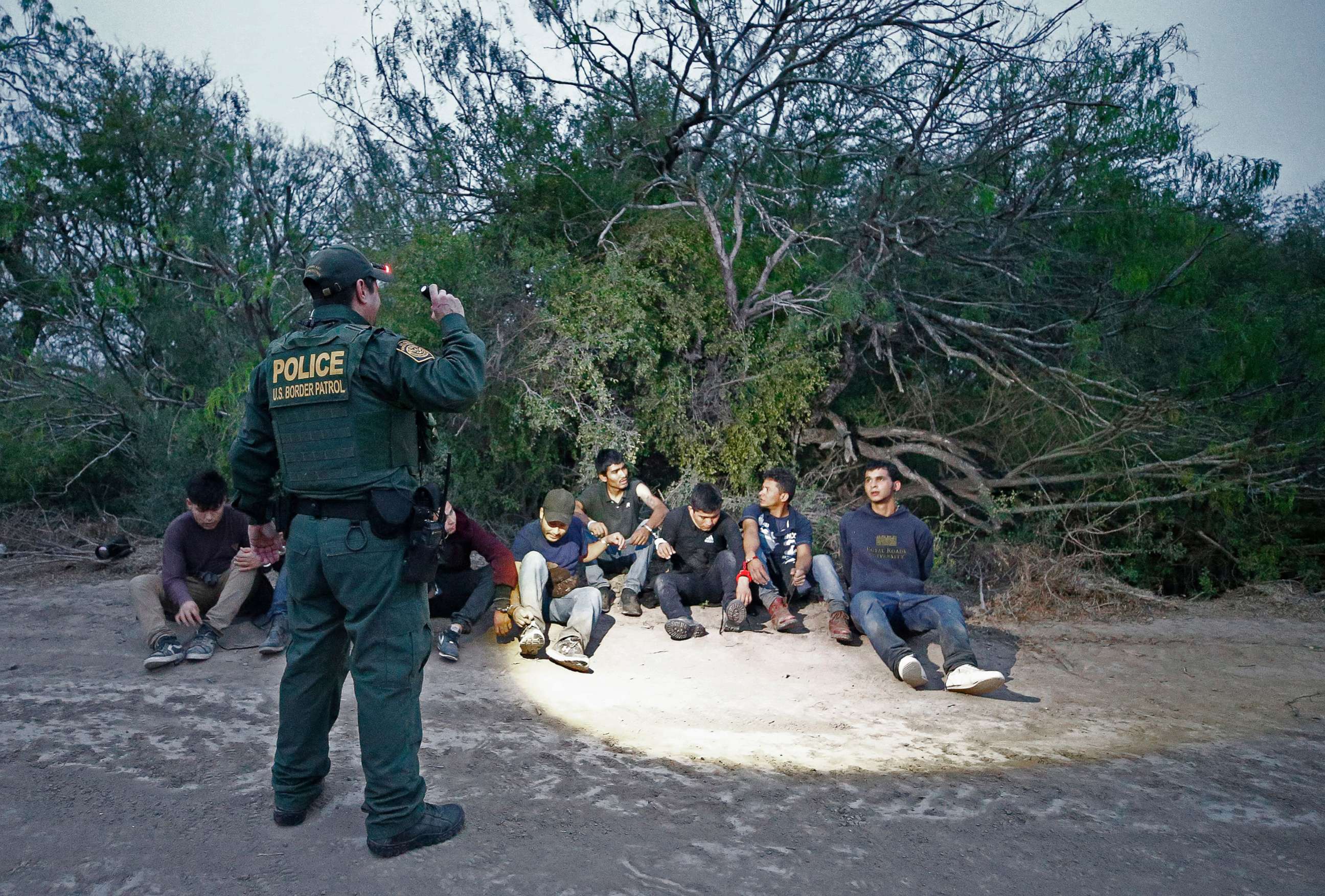 PHOTO: U.S. Border Patrol agents apprehend people suspected of crossing the Rio Grande River to enter the United States illegally near McAllen, Texas, March 4, 2020.