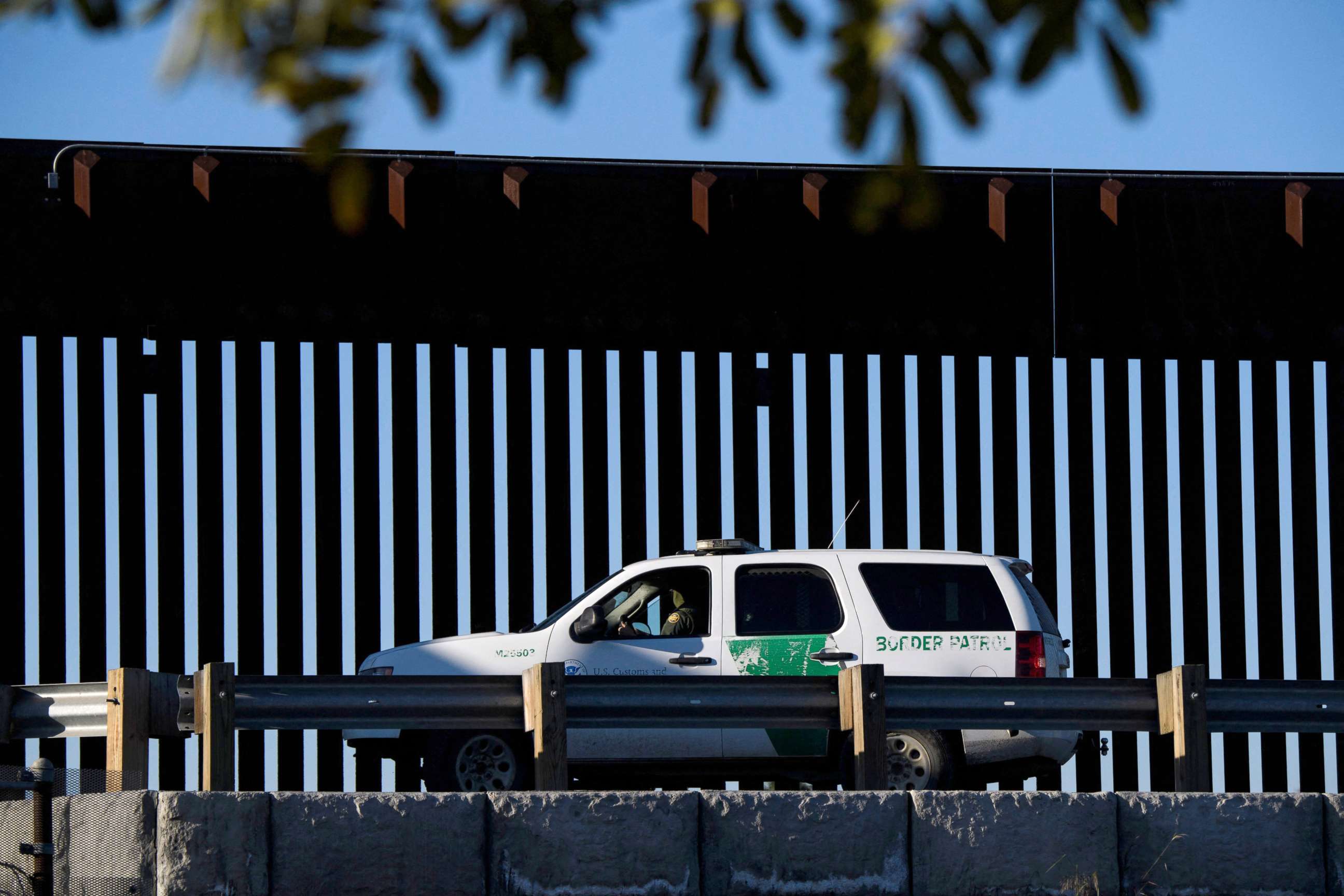 PHOTO: A US Border Patrol agent sits in a vehicle along a border wall near the US Customs and Border Protection (CBP) San Ysidro Port of Entry at the US Mexico border, Feb. 19, 2021, in San Diego, California.