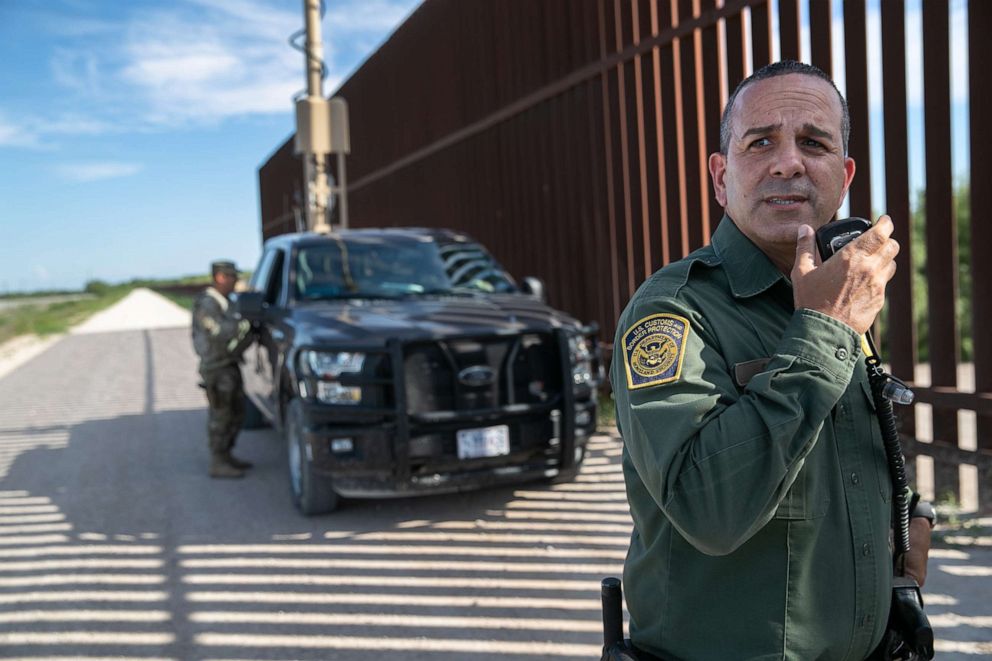 PHOTO: U.S. Border Patrol agent Carlos Ruiz spots a pair of undocumented immigrants while coordinating with active duty U.S. Army soldiers near the U.S.-Mexico border fence on Sept. 10, 2019 in Penitas, Texas.