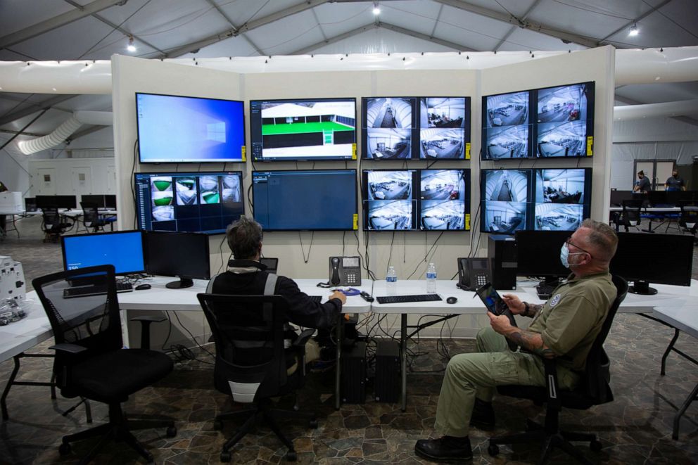 PHOTO: Agents watch monitoring screens as temporary U.S. Customs and Border Protection processing facilities are constructed in anticipation of a surge in migration in Donna, Texas, Feb. 8, 2021.