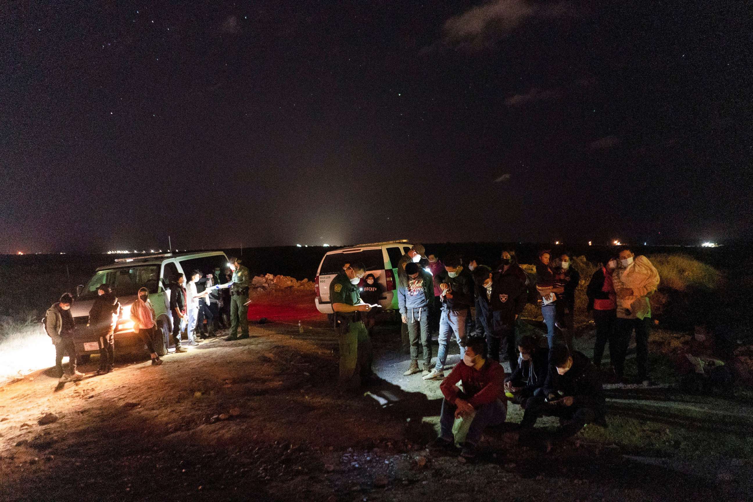 PHOTO: Asylum-seeking migrants' families wait to be transported by the U.S. Border Patrols after crossing the Rio Grande river into the United States from Mexico in Roma, Texas, April 5, 2021. 
