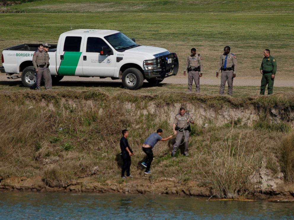 PHOTO: U.S. border patrol agents receive migrants after crossing the Rio Bravo, seen from Piedras Negras, Mexico, Feb. 20, 2019.