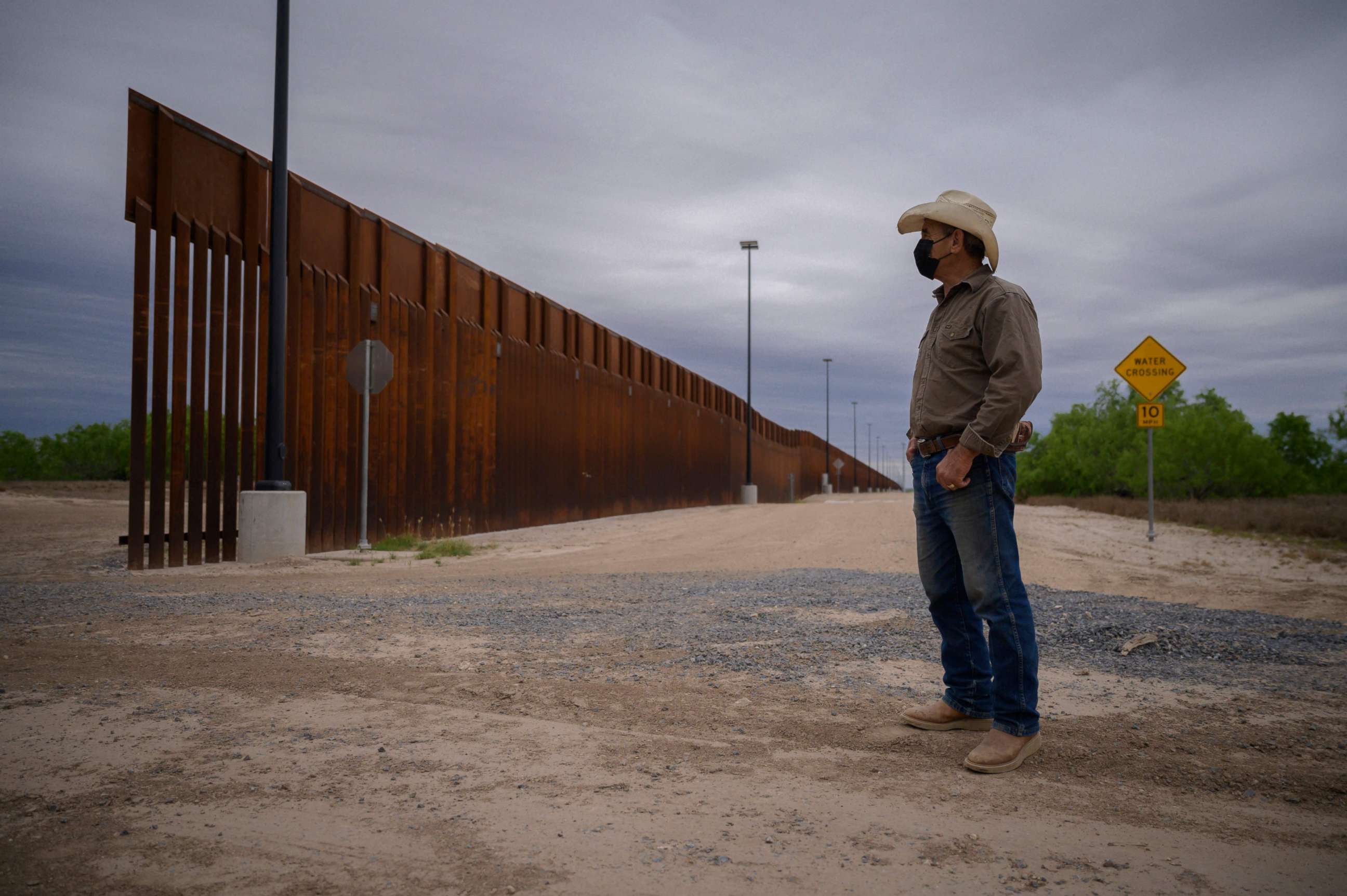 PHOTO: In a photo taken on March 28, 2021, ranch owner Tony Sandoval stands before a portion of the unfinished border wall that former President Donald Trump tried to build, near the southern Texas border city of Roma.
