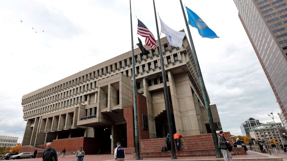 PHOTO: In this Oct. 30, 2014, file photo, flags fly at half-staff outside City Hall in Boston.
