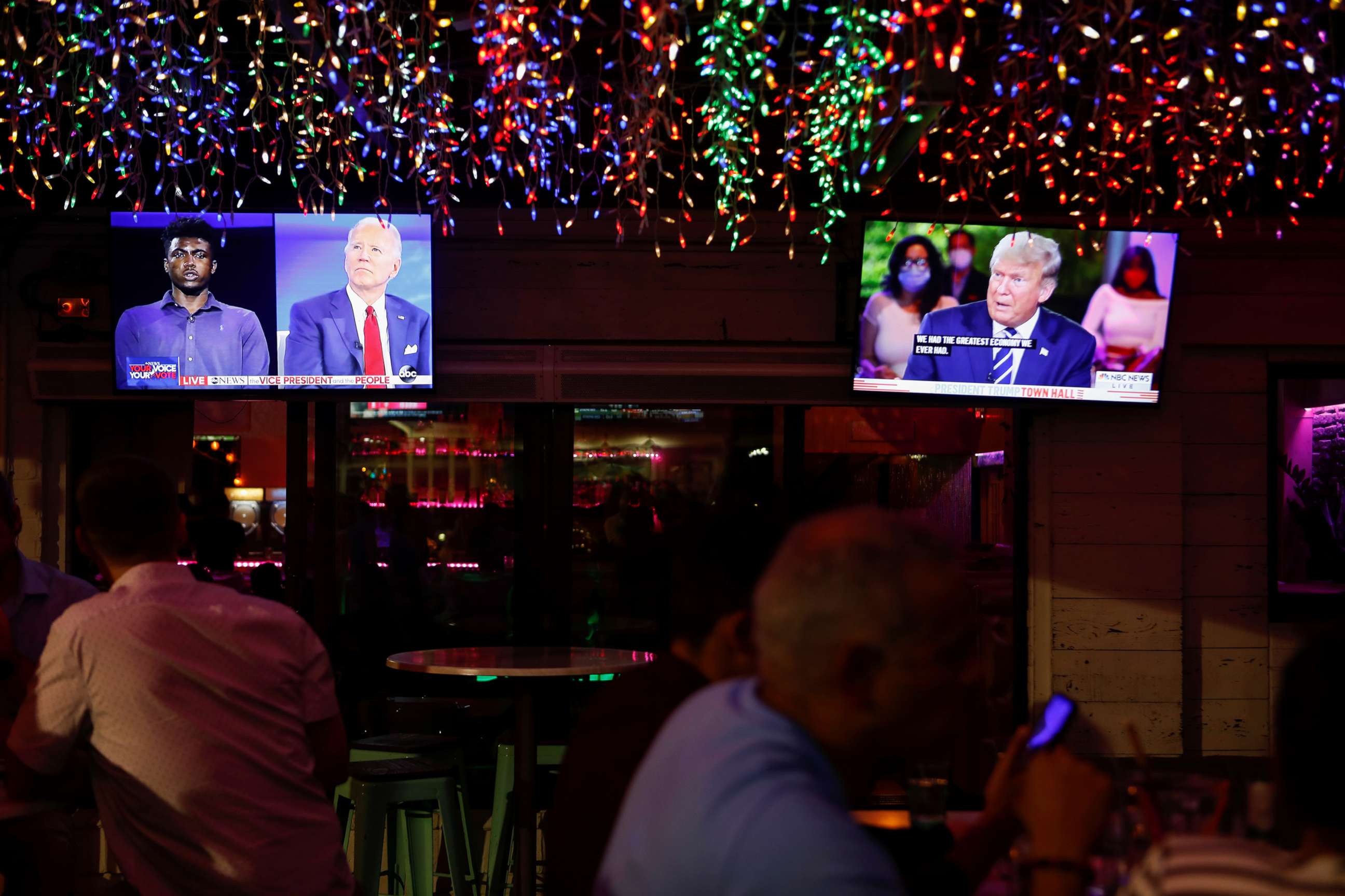 PHOTO: The dual town halls of Democratic presidential candidate Joe Biden and President Donald Trump are seen on television monitors at Luv Child restaurant ahead of the election in Tampa, Fla., Oct. 15, 2020.