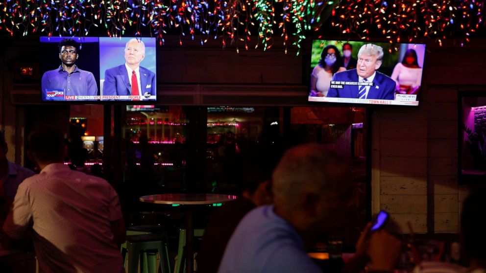 PHOTO: The dual town halls of Democratic presidential candidate Joe Biden and President Donald Trump are seen on television monitors at Luv Child restaurant ahead of the election in Tampa, Fla., Oct. 15, 2020.